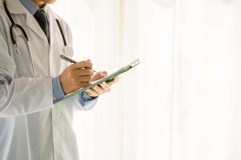 a doctor signing patient's documents