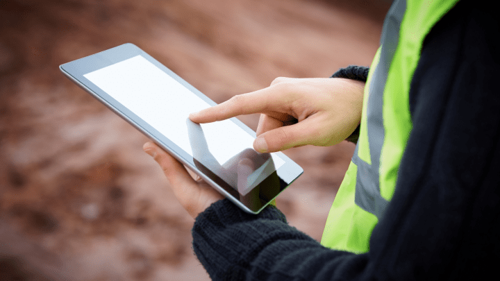 picture of a man holding a digital construction quote or contract